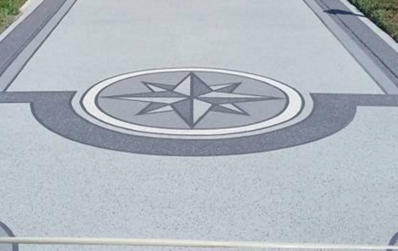 Decorative compass design in a coated driveway